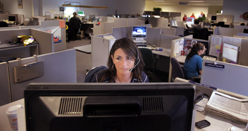 Holly Morse, a customer service representative, talks with a customer in the call center at Wright Express.