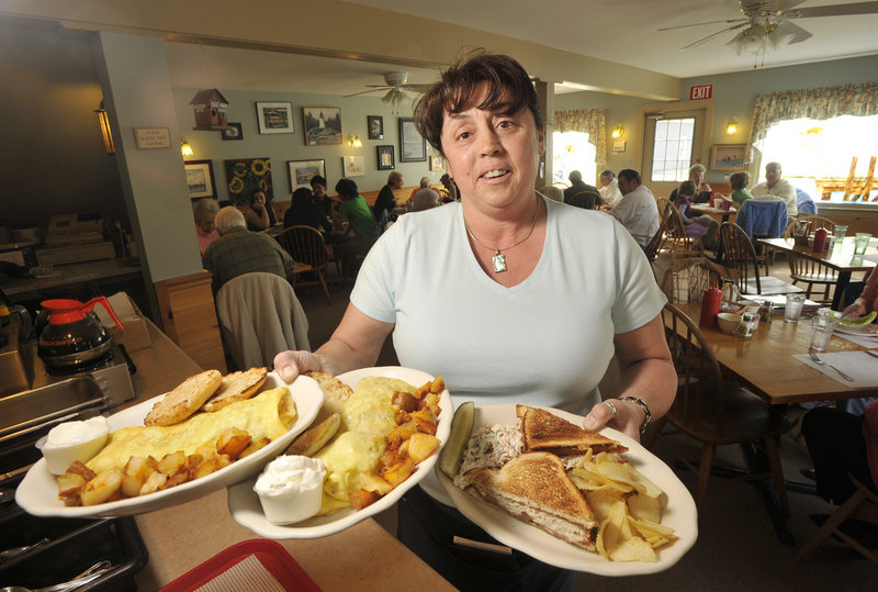 Server Cindy LeBarge hoists an armload of groaning plates at All Day Breakfast in Kennebunk.