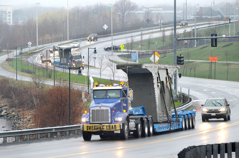 The first of more than 350 precast concrete bridge segments make their way along the Fore River Parkway on Tuesday, on their way to the site of the new Veterans Memorial Bridge that links Portland s West End to South Portland. By Thursday, officials said, contractors expect four of the massive 40-foot-long segments to be transported up Interstate 295 to Exit 5 each weekday until this fall.