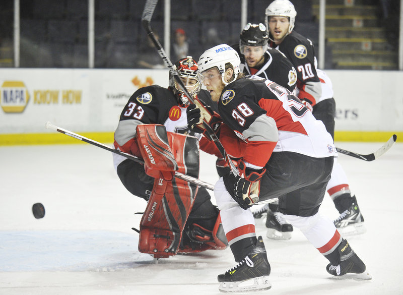 Tim Conboy and goalie David Leggio of the Pirates watch as the puck bounces away Wednesday night during Binghamton's victory in the opener of their AHL playoff series at the Cumberland County Civic Center.