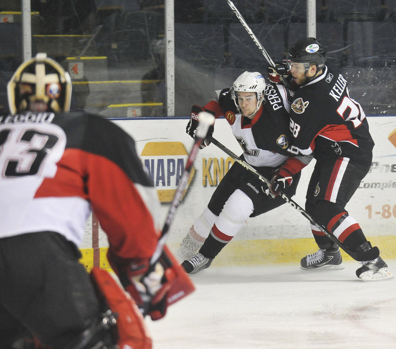 Ryan Keller of Binghamton, right, tries to ride Portland's Dennis Persson off the puck in front of goalie David Leggio during Game 1 of their division series Wednesday night at the Cumberland County Civic Center. The Senators won, 3-2.