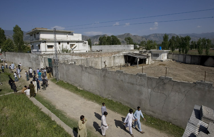 Media and local residents gather today outside the house in Abbottabad, Pakistan, where al-Qaida leader Osama bin Laden was killed.