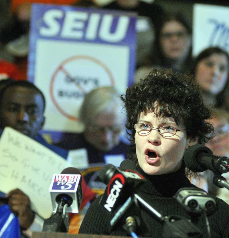 Tammy Trask, of the Maine Association of Interdependent Neighborhoods, speaks during a news conference about Gov. LePage's proposed state budget on this morning in the State House's Hall of Flags in Augusta.