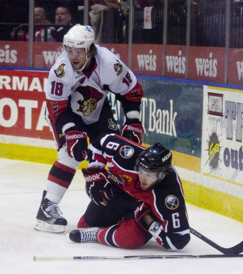 Binghamton’s Zack Smith, left, checks Portland’s Brian O’Hanley in Game 4 of their playoff series Monday night in Binghamton, N.Y. Portland lost, 6-1.