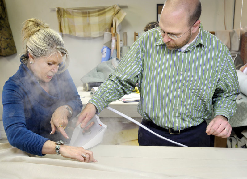 Nancy Seiler, owner of The Drapery Trading Co., gives reporter Ray Routhier some guidance on the finer points of ironing draperies.