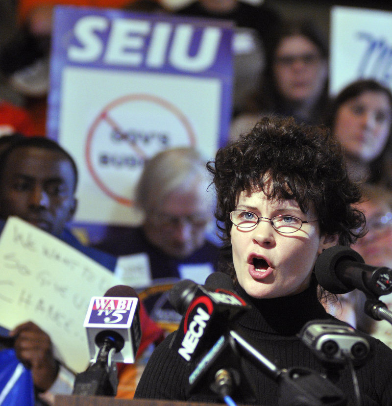 Tammy Trask of the Maine Association of Interdependent Neighborhoods criticizes Gov. Paul LePage’s package of budget cuts at a news conference Wednesday in Augusta.