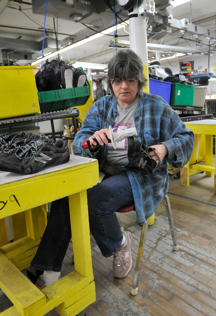 Debbie Foss washes shoes at New Balance. In April, the company launched a custom-made shoe program that allows customers to design their own New Balance shoes online.