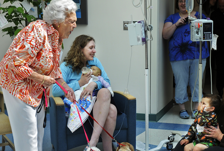 Barbara Bush reacts after Jeffrey Davis, 2, gets a kiss from one of the former first lady's dogs.