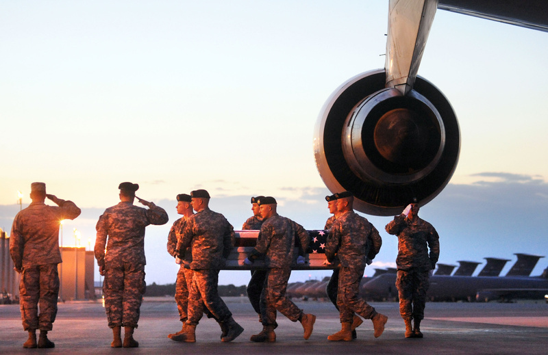 A transfer team carries the remains of Spc. Wade A. Slack, who was from Waterville, on May 8, 2010. Slack, 21, died in Afghanistan.