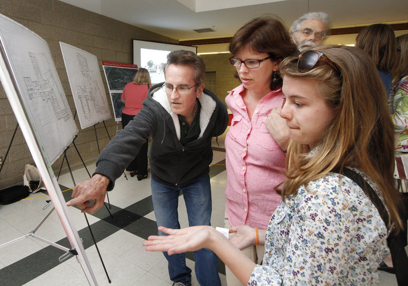 Gaby Ferrell, right, an eighth-grader in South Portland, talks about plans for the renovation and expansion of South Portland High School with her parents, Tim and Courtney Ferrell, during a community open house at the school. Gaby, a member of the building committee, said she's "happy for the younger kids."