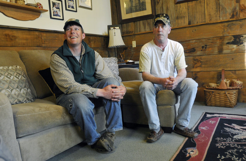 James “JR” Mabee, left, and Kim Vose, both guides in Grand Lake Stream, share fishing stories at Indian Rock Camps. “We try to promote catch and release,” said Mabee.