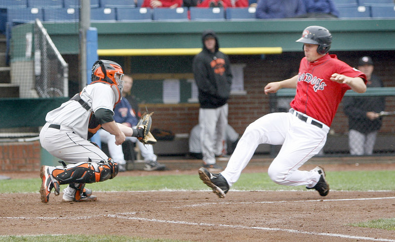 Ryan Lavarnway of the Sea Dogs slides safely into home as Bowie catcher Steve Lerud waits for the throw Sunday at Hadlock Field. Lavarnway drove in three runs and hit his Eastern League-leading 14th home run.