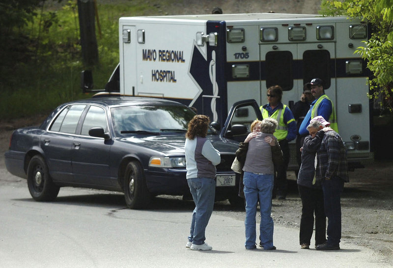 Relatives of the victims of a domestic shooting gather about a mile from where police say Steven Lake killed his estranged wife and two children.