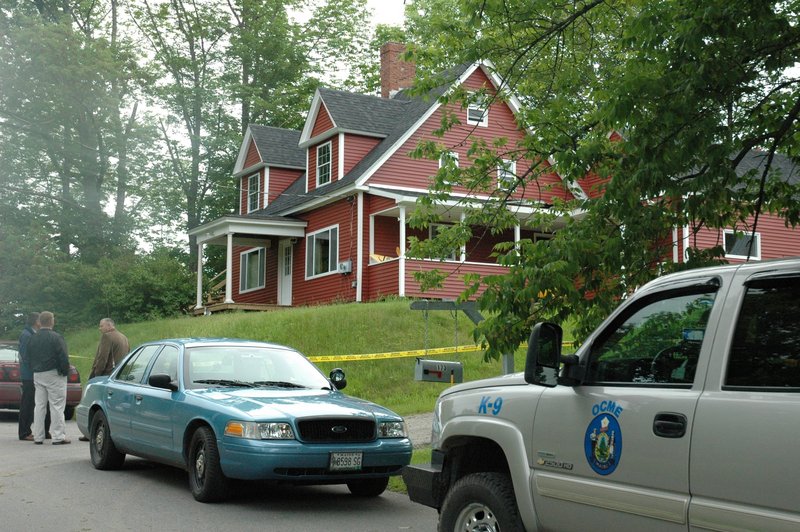 Police vehicles sit outside the Shore Road home in Dexter where Steven Lake is believed to have killed his estranged wife and children Monday. Amy and Steven Lake split up in 2010 and she had a restraining order against him, police said.