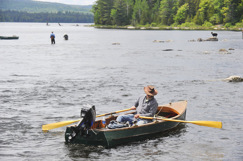 Martin Meier of Lisbon Falls rows to shore after fishing the popular pool.
