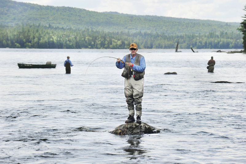 Art Colvin of Freeport plays a fish in the large pool below Upper Dam recently.