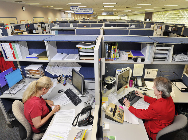 Julie Hatch, left, customer service representative team leader, and Jill Schlick, customer service representative coordinator, work at the technical center at Bangor Savings Bank.