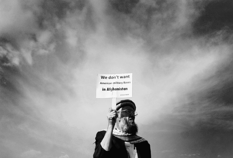 An Afghan protester holds a banner during a peaceful protest in Kabul, Afghanistan, on April 7. With President Barack Obama’s plans to end U.S. combat operations in Afghanistan by 2014, key questions remain: Just what was accomplished in the 10 years of U.S. involvement, and can any kind of lasting reconciliation result?