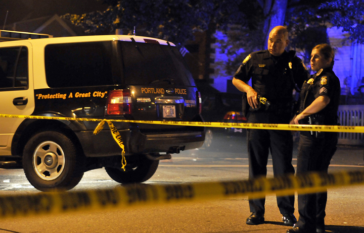 Portland Police officers investigate the scene of a crash near Congress and Munjoy streets that seriously injured a man.