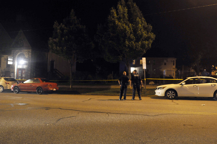 Police on Monday stand near the empty parking space that was occupied by Jason Beaudoin's SUV. Police say Beaudoin backed up and intentionally slammed into the white Honda Accord at right. Witnesses say the Accord was pushed back several feet.