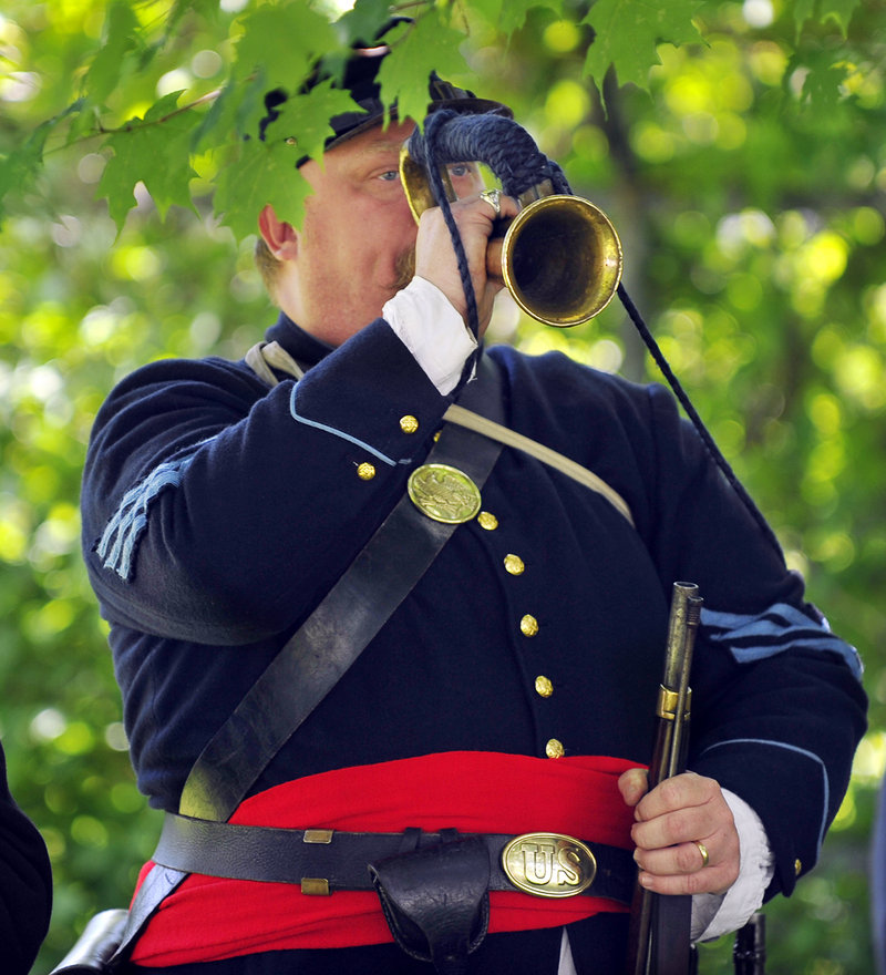 Sgt. Steve Peterson, 3rd Maine Infantry reenactment group, plays taps at the ceremony.