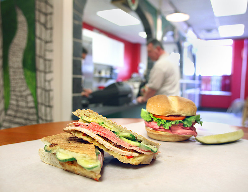 The El Cubano, left, and the slow-roasted top round of certified Angus beef sandwich are among the specialties at Cobblestones in Portand's Monument Square.