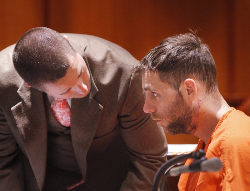 Jonathan Mitchell of Veazie listens to attorney Peter Richard during an April 2011 bail hearing in Cumberland County Superior Court. Police shot Mitchell while trying to detain him after reports that he had broken into his ex-wife’s apartment.