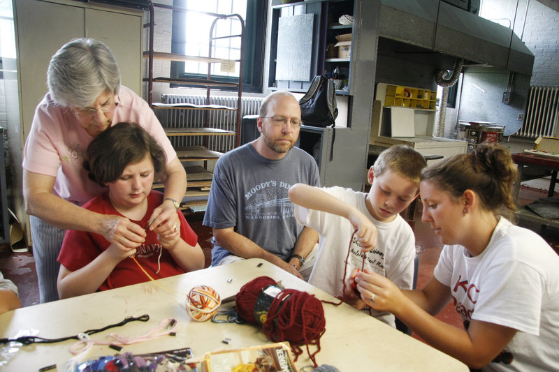 Ray Routhier, center, observes Keera Allen, far right, a counselor with the South Portland Parks and Recreation Department, as she helps Ben Gaudreau, 10, learn how to knit at Mahoney Middle School. At left, knitting instructor Kathy Tolliver works with Sophia Devou, 10.