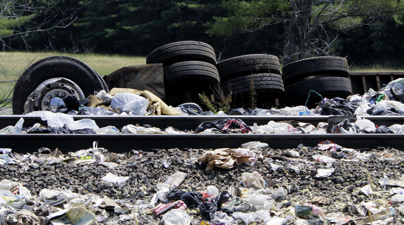 Remnants of the tractor-trailer sit along the tracks. Witnesses said the truck’s brakes locked before it skidded into the train’s path.