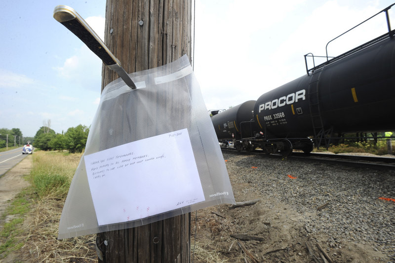 A plastic-wrapped thank-you note to first responders is tacked to a utility pole near the site of Monday’s fatal collision on Route 4 in North Berwick. A conductor and an assistant conductor helped evacuate 112 passengers in five cars.