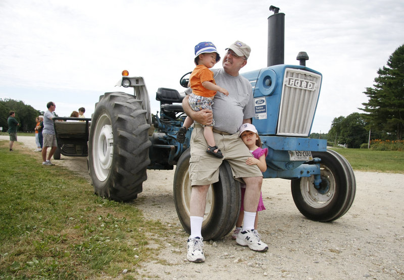 Gary Kerns of Topsham visits Wolfe's Neck Farm with his grandchildren Liam Jessie, 2, of Topsham and Paige Kerns, 4, of Bangor.