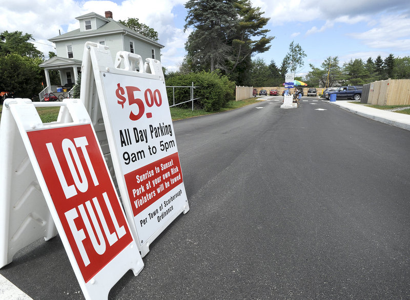 The 61 spaces of this town-owned lot at Higgins Beach fill up quickly on sunny days. The town is also experimenting with on-street parking at the site.