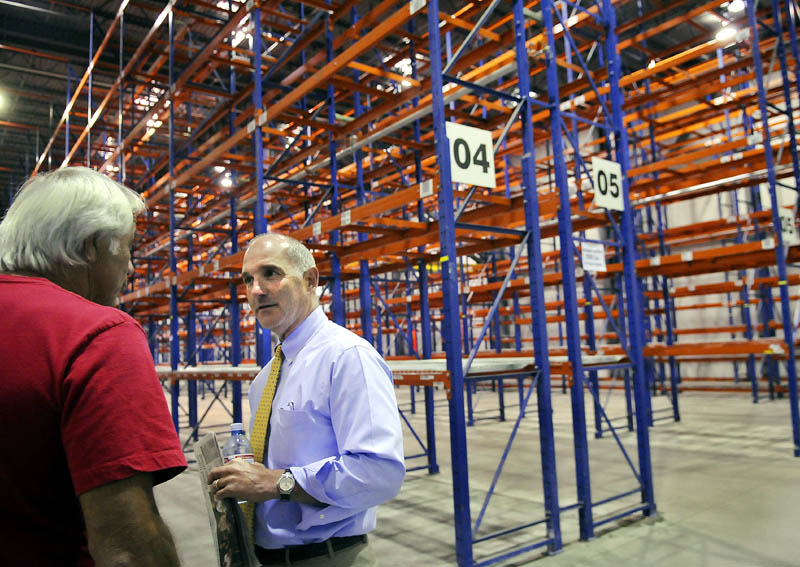 Nick Alberding, right, managing partner and an owner of Pine State Trading, gets a tour through the refrigerated storage at the former Associated Grocers warehouse from former AG employee Tom Doucette before an Aug. 8 auction for AG’s buildings in Gardiner. Pine State Trading purchased the property from Camden National Corporation on Wednesday.