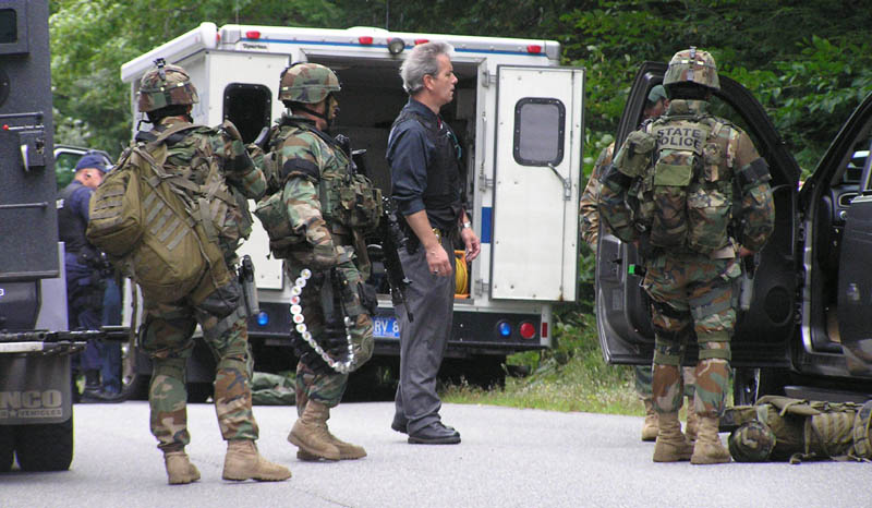 Staff photo by Scott Monroe State and local police converge on North Pond Road in Winslow Thursday afternoon where a man barricaded himself in a home and threatened to kill himself.