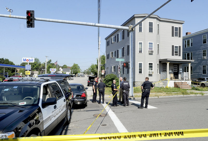 Portland police investigate a fatal shooting that happened early Monday outside 4-6 Massachusetts Ave. Police were called to the Mobil gas station at 1196 Congress St., in background, and found a man lying on the sidewalk in front of the station. He was pronounced dead at the scene, police said.