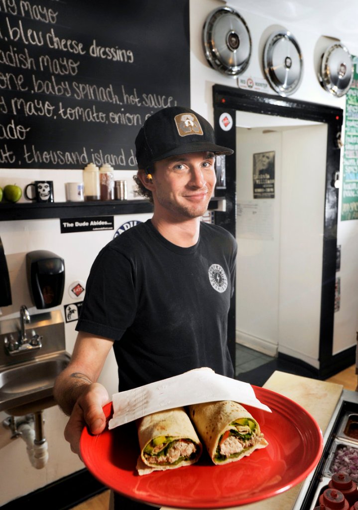 Jeffrey Goodman with a chicken salad and avocado wrap known as the Chavo at Market Street Eats