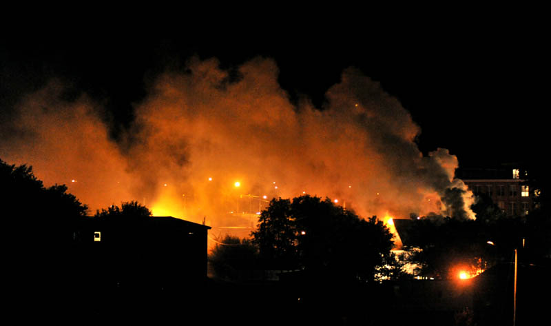Staff photo by Michael G. Seamans Firefighters from Waterville and WinslowFire Departments responded to a structure fire on Water Street Monday evening. The apartment building was a total loss.