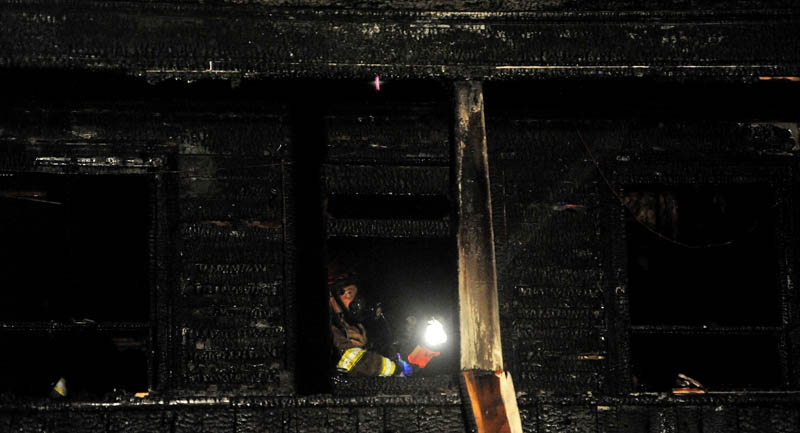 Staff photo by Michael G. Seamans Firefighters from Waterville and WinslowFire Departments responded to a structure fire on Water Street Monday evening. The apartment building was a total loss.