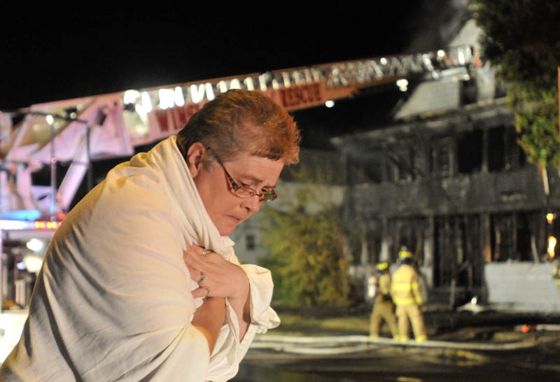 Staff photo by Michael G. Seamans Firefighters from Waterville and WinslowFire Departments responded to a structure fire on Water Street Monday evening. The apartment building was a total loss.