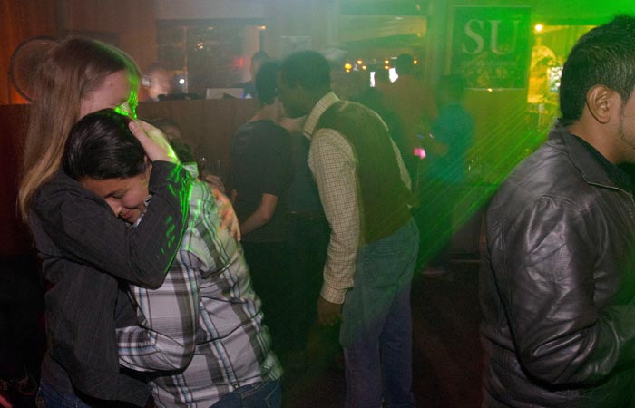 A woman who is active-duty in the Navy embraces her partner after midnight during a celebration for the end of the policy commonly known as "don't ask, don't tell" in the military today in San Diego.