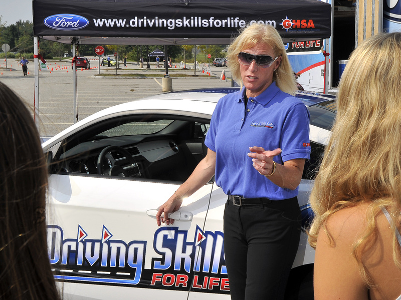 Stephanie Reaves, a lead driving instructor with the Ford Driving Skills for Life team, talks about car maintenance and safe driving at Scarborough High School on Wednesday. Reaves, who was raised in Freeport and Durham, will be at Bonny Eagle High School today.