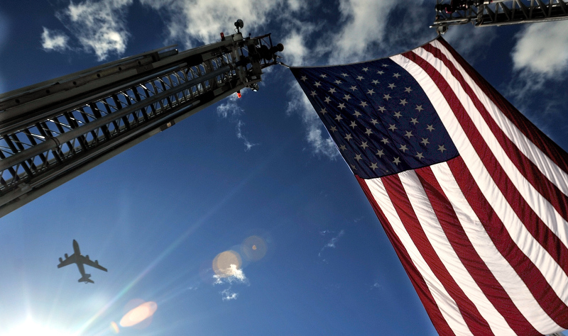 Staff photo by Michael G. Seamans A military refueling plane performs a fly-by during the 48th Confederation of Firefighters Convention for the State parade in Waterville Saturday morning.