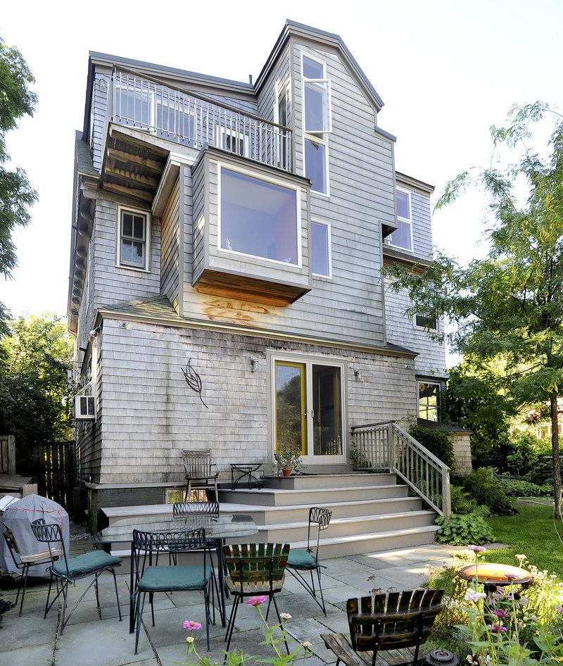 The rear of the house has an edgier, more modern look, thanks to a three-story addition that suits the owners’ needs as work-at-home graphic artists.