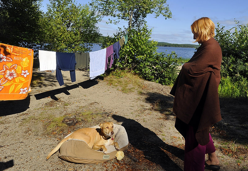Jenni DeSio from New Jersey camps with her dog and a friend at Donnell Pond. “Maine has a peace I haven’t found anywhere,” DeSio said.