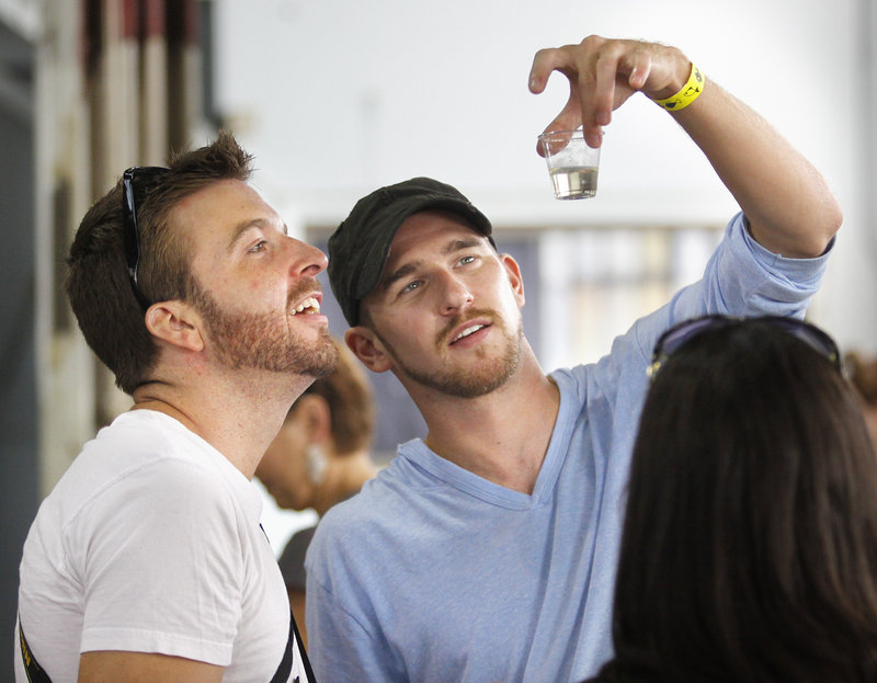 Neil DuPaul of Manchester, N.H., left, and Leif Anderson of Salem, N.H., investigate the viscosity of a sample of Honey Maker Dry Mead made by Maine Mead Works in Portland.