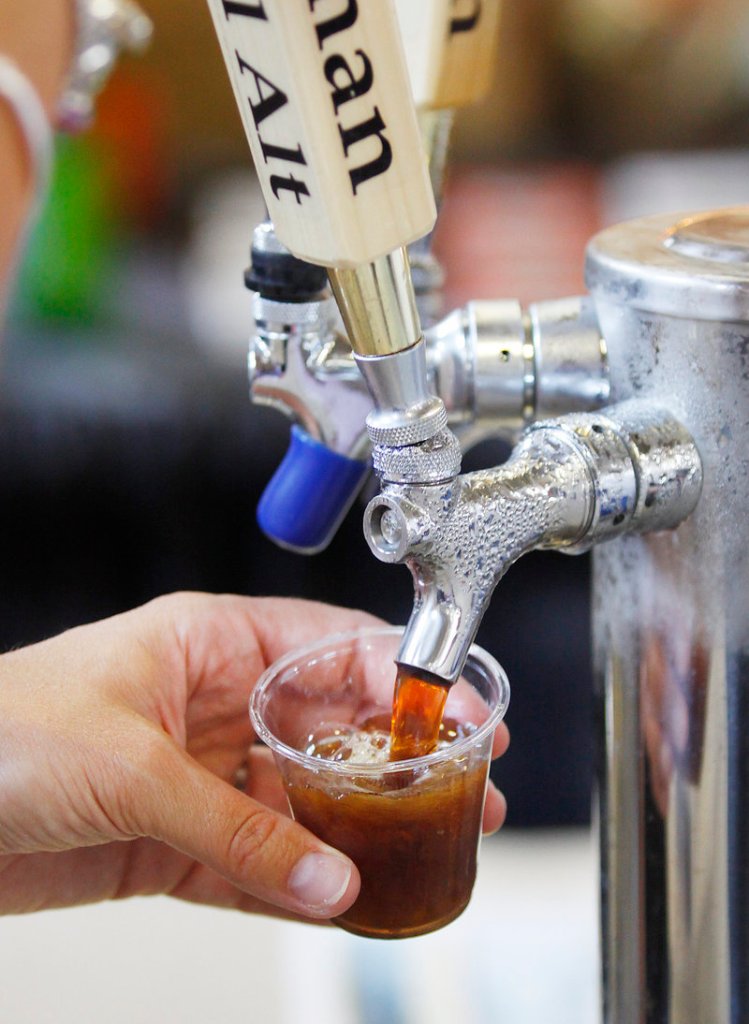 Victoria Noel of Tuckerman Brewing Co. pours a sample of Headwall Alt at the annual Portland Brew Festival in Portland on Saturday.