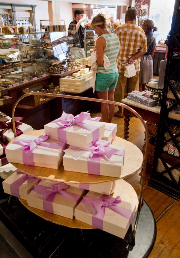 Tourists buy candy at Harbor Candy Shop in Ogunquit on Friday. "We've had a huge influx of Canadians this year," said manager Colleen Osselaer. A favorable exchange rate and increased advertising have helped draw more Canadians.