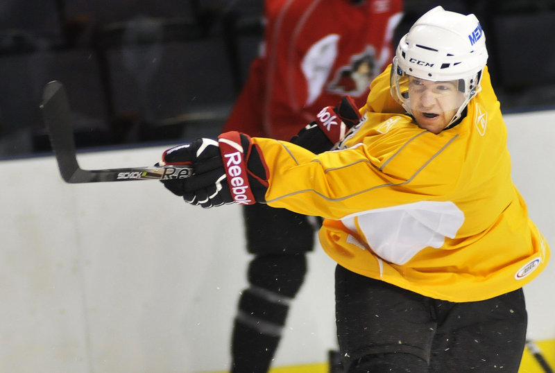 Left wing Ryan Duncan fires a shot on goal Monday at the Civic Center. Intra-squad scrimmages begin today.