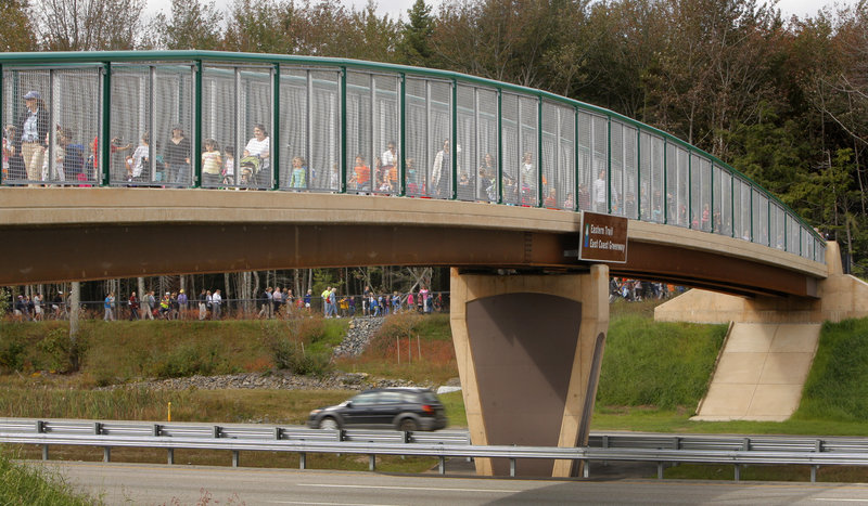 Pupils from Kennebunk Elementary School and Mildred L. Day School in Arundel cross the new Eastern Trail Bridge over the Maine Turnpike in Kennebunk on Wednesday to help mark the official opening of the span.