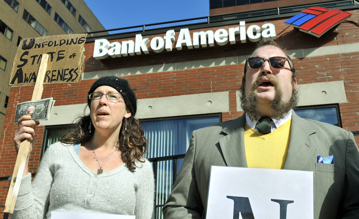 Rebecca Buttignol of York and John Schreiber of Portland protest against Bank of America at One City Center today. The demonstration was organized by Occupy Maine.